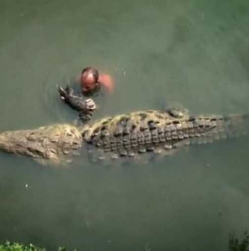 Вижте къде хвърлят кръста в езеро с крокодил
